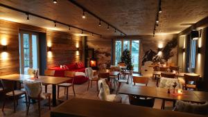 a restaurant with tables and chairs and a couch at Mariandl am Meer in Binz