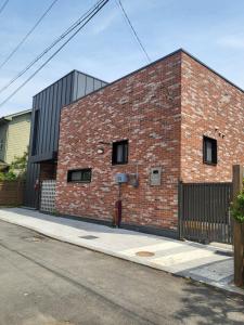 a red brick building on the side of a street at Rest house in Goyang