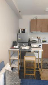 a kitchen with a table and chairs in a room at Be Housed Studio Bldg 302 in Lapu Lapu City +2 photos
