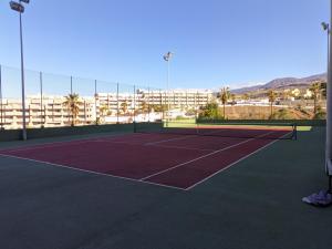 a tennis court with a tennis racket on it at Brisa del Teide - Free parking in Playa Paraiso