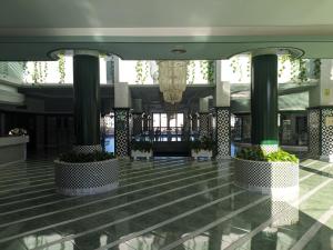 a lobby of a building with columns and plants at Brisa del Teide - Free parking in Playa Paraiso +45 photos