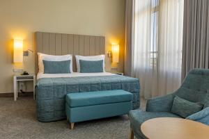 Postel nebo postele na pokoji v ubytování Montebelo Girassol Maputo Hotel