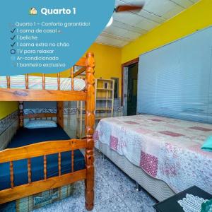 two bunk beds in a room with yellow walls at Sun House in Saquarema