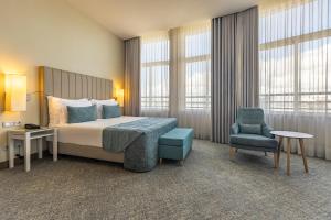 Postel nebo postele na pokoji v ubytování Montebelo Girassol Maputo Hotel + 37 fotografií