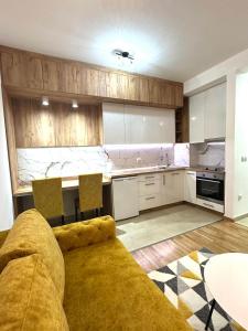 a kitchen with a couch and a table in it at Apartman Most in Bosanska Gradiška +8 photos