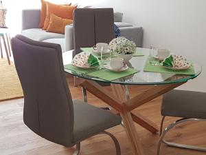 a dining table with two chairs and a glass table at Sepp in Bad Tölz
