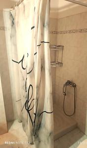 a white shower curtain in a bathroom with a shower at Dimi House in Ágios Matthaíos +9 photos