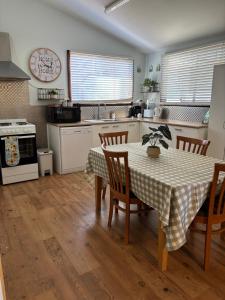 a kitchen with a table and chairs and a kitchen with a stove at Sage Cottage in Cowaramup