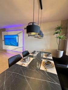Un comedor con una mesa y sillas negras. en Terra Palm Golf Apartment 3, en Las Casicas