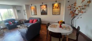 a living room with a couch and a table and chairs at Estudio Bohemio in La Paz +7 photos
