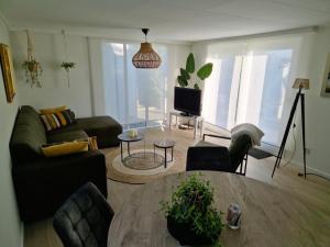 a living room with a table and a couch at Chalet T18 in Makkum