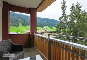 a balcony with a view of the mountains at Grischa - Das Hotel Davos in Davos