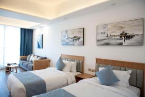 Voodi või voodid majutusasutuse Huizhou Xunliao Bay Qingpu Hotel toas