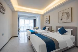 Voodi või voodid majutusasutuse Huizhou Xunliao Bay Qingpu Hotel toas