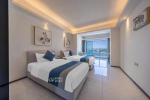 Voodi või voodid majutusasutuse Huizhou Xunliao Bay Qingpu Hotel toas