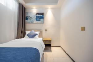 Voodi või voodid majutusasutuse Huizhou Xunliao Bay Qingpu Hotel toas