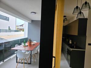 a kitchen and dining room with a table and chairs at Miliva Apartments in Vir
