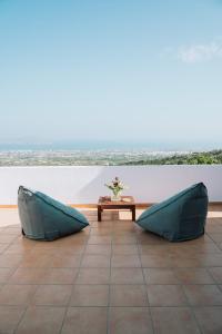 two pillows sitting on a tile floor with a table at Infinity II - Modern Family Retreat in Kos in Lagoúdi Zía