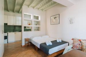 a bedroom with a bed and a kitchen at Infinity III - Tranquil Studio Retreat in Kos in Lagoúdi Zía