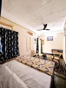 a bedroom with a bed and a table in a room at Nav Durga Homestay in Udaipur +74 photos