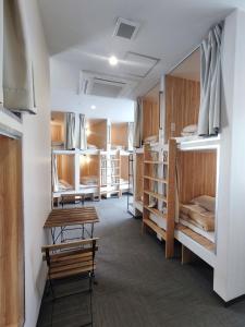 a room filled with lots of bunk beds at KOREGA ! Hostel Osaka Namba in Osaka
