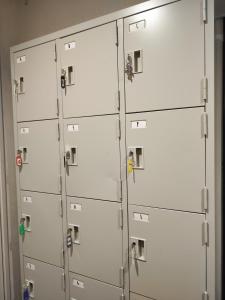 a group of white lockers with keys on them at KOREGA ! Hostel Osaka Namba in Osaka