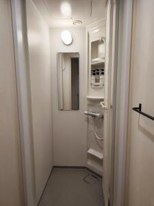 a small bathroom with a toilet and a mirror at KOREGA ! Hostel Osaka Namba in Osaka +49 photos