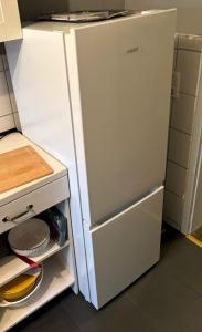 a white refrigerator with its door open in a kitchen at Le petit Charme - Wohnen in einer historischen Villa in Suhl