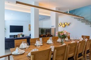 a dining room with a long table and chairs at Villa Panorama Poreč in Mugeba