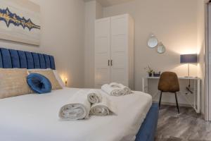 a bedroom with a bed with towels on it at Suite Da Vinci in Pavia +88 photos