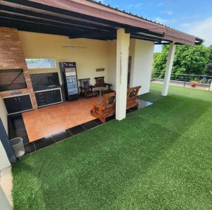 a house with a patio with green grass at Amplia y Moderna Casa, en inmejorable ubicación in Ciudad del Este