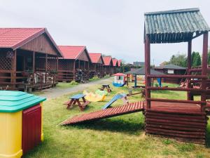 a group of children playing on a playground at Domki u Karasia in Rusinowo +15 photos
