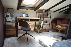 a room with a desk and a chair in a room at Къща за гости Mia Maria in Tutrakan