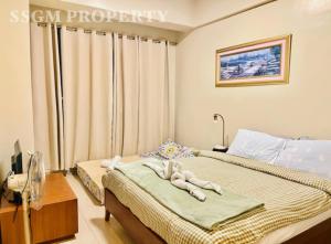 a bedroom with two beds with towels on them at Mactan Newtown Feels like Home in Lapu Lapu City