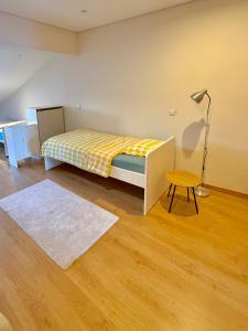 a bedroom with a bed and a table and a lamp at Âmbar Guest House in Braga +38 photos