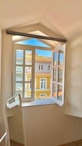 a window with a view of a building at Âmbar Guest House in Braga