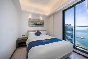 Voodi või voodid majutusasutuse Huizhou Xunliao Bay Qingpu Hotel toas