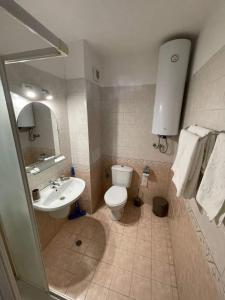 a bathroom with a toilet and a sink at К-с Сън Коуст in Sveti Vlas +7 photos