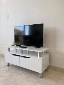 a white entertainment center with a flat screen tv on it at К-с Сън Коуст in Sveti Vlas