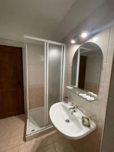 a bathroom with a shower and a sink and a mirror at К-с Сън Коуст in Sveti Vlas