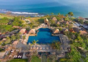 an aerial view of a resort with a swimming pool and the ocean at AYANA Resort Bali in Jimbaran