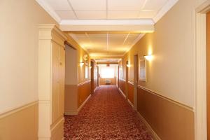 an empty hallway in a building with a hallwayngth at The Glengate Hotel & Suites in Niagara Falls