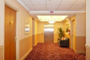 an office hallway with a exit sign on the ceiling at The Glengate Hotel & Suites in Niagara Falls