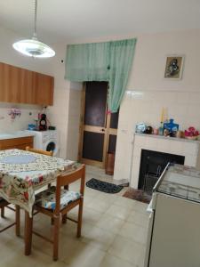 a kitchen with a table and a dining room at Casa di Francesca in Ruvo del Monte +8 photos