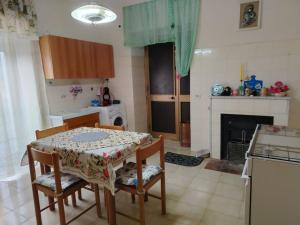 a kitchen with a table and chairs and a kitchen with a fireplace at Casa di Francesca in Ruvo del Monte