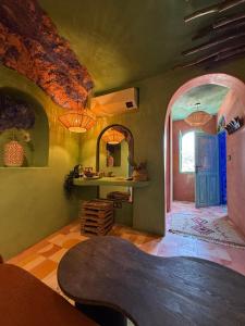 a room with a table and an archway in a house at Casa Amina in Chefchaouene