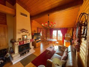 a living room with a couch and a fireplace at Charmant Chalet avec Cheminée et Terrasse aux Angles - FR-1-593-128 in Les Angles