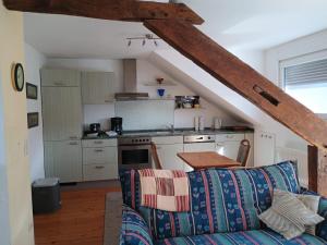 a living room with a couch and a kitchen at Gästehaus Burg Molbach in Kreuzau
