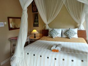 Postel nebo postele na pokoji v ubytování Umah Ubud Guest House
