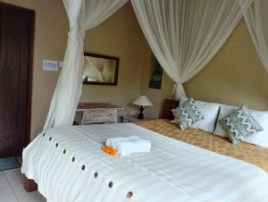 Postel nebo postele na pokoji v ubytování Umah Ubud Guest House